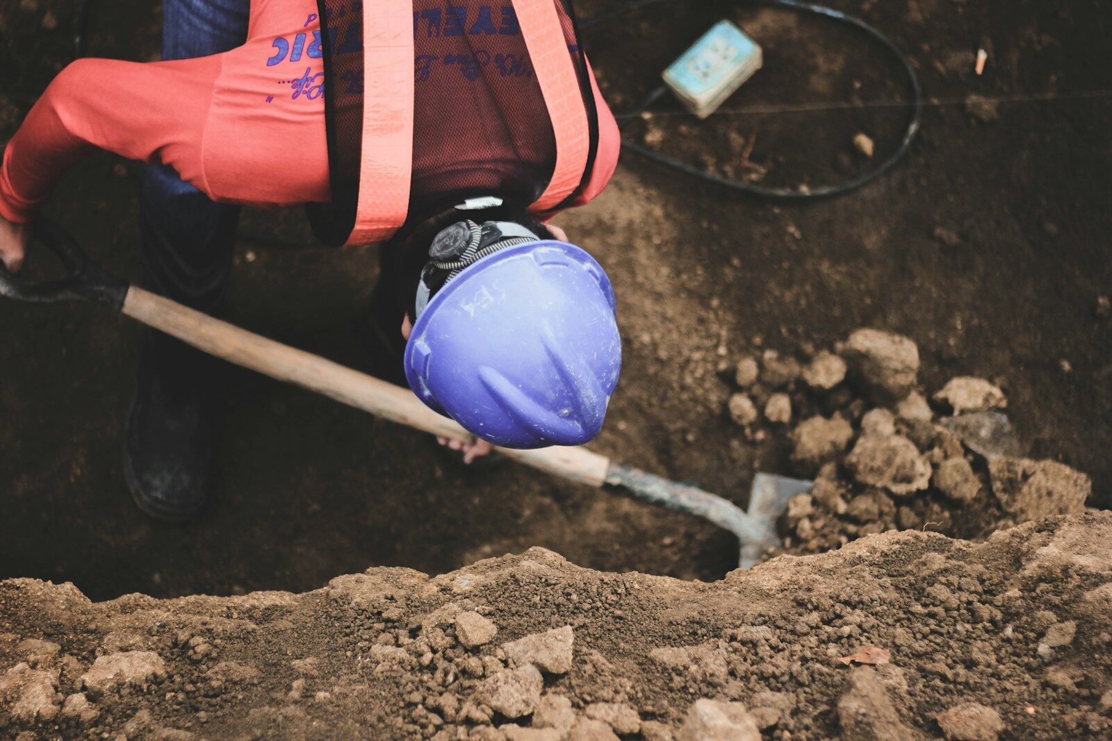 A man digging a hole with a shovel